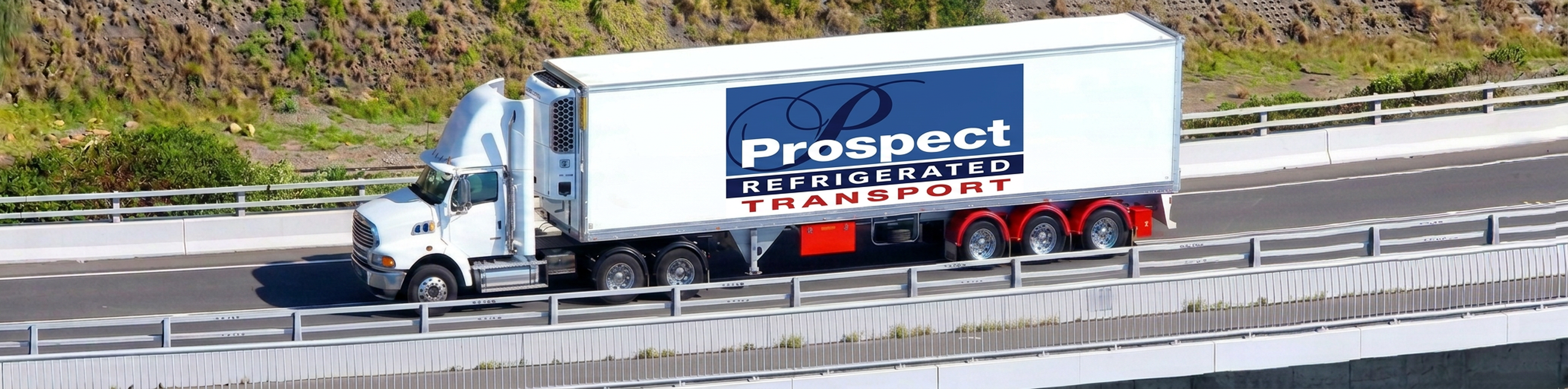 Refrigerated trucks on coastal bridge